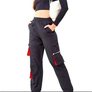 UNISEX MULTI- POCKETED BLACK AND RED SPACE SUIT PANTS.